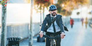 man in suit riding a bike